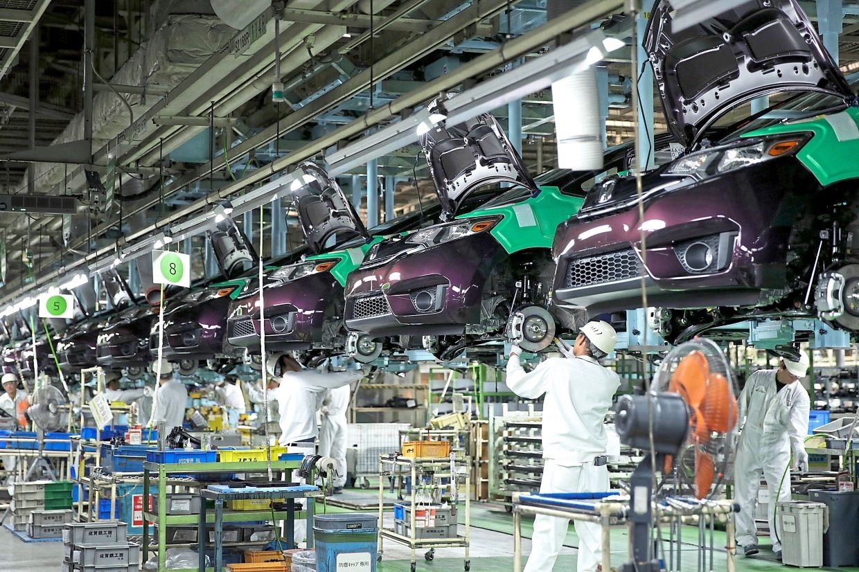 Japan factory activity returns to growth after 11-month contraction, PMI shows