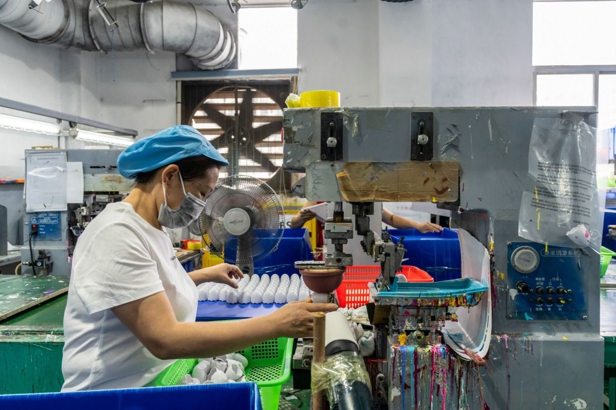 China's factory activity returns to growth in June, Caixin PMI shows