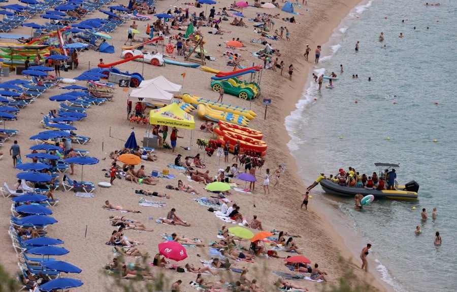Spaniards struggle to enjoy their own beaches in tourist deluge
