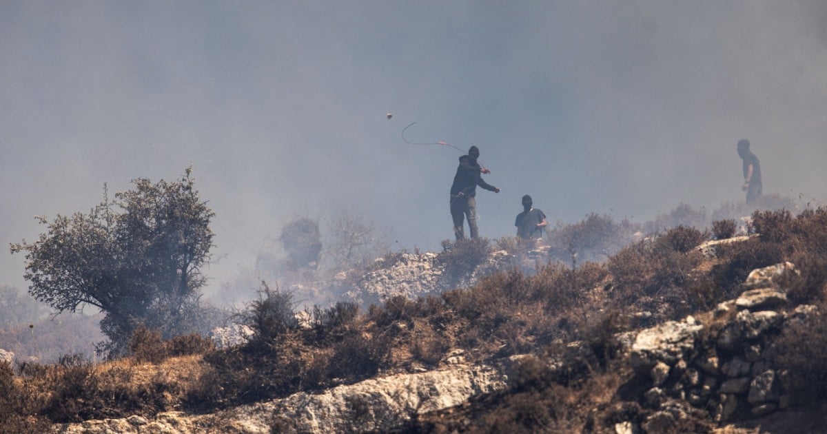 Settlers and Palestinians clash during march in West Bank village
