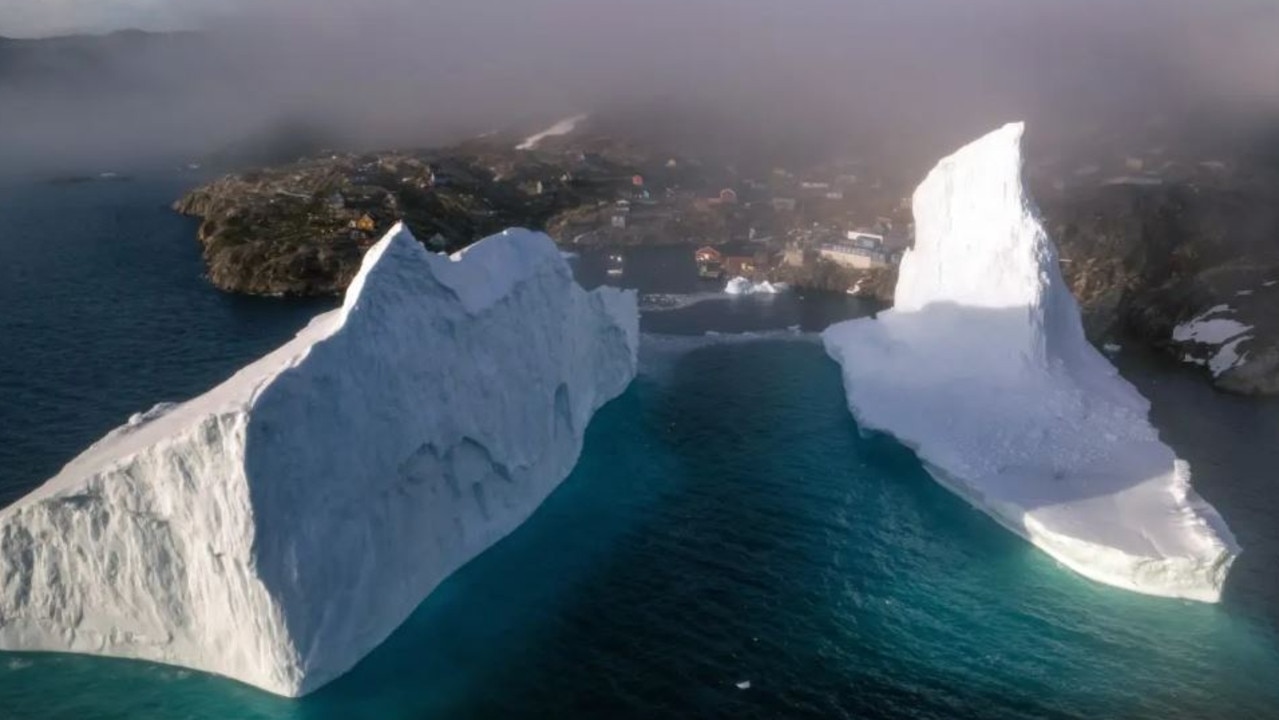 Greenland village wakes up to titanic iceberg dangerously close to homes