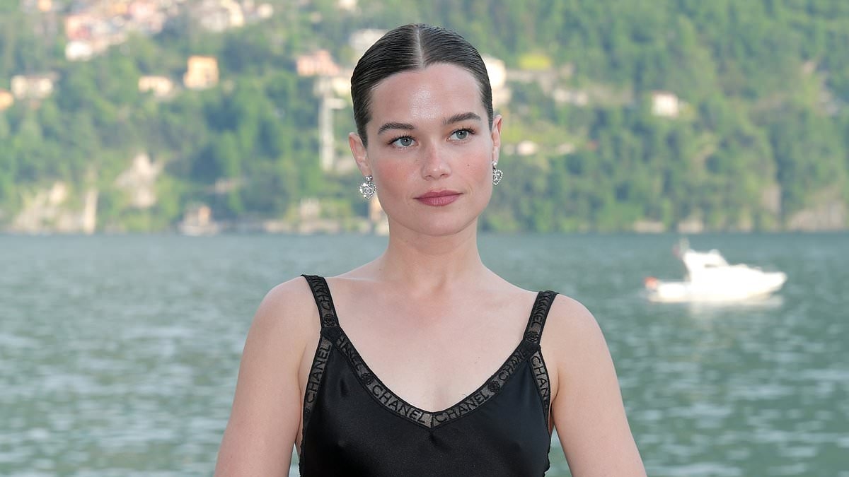 White Lotus star Sarah Catherine Hook looks elegant in a black satin dress as she joins chic Margaret Qualley and Lupita Nyong'o at Chanel Cruise fashion show on Lake Como