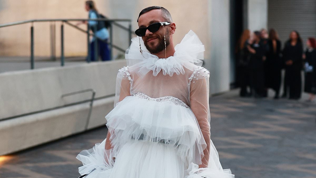 Controversial influencer who was slammed for cringeworthy entrance at last year's Australian Fashion Week returns in 2025 wearing wedding dress held up by four assistants