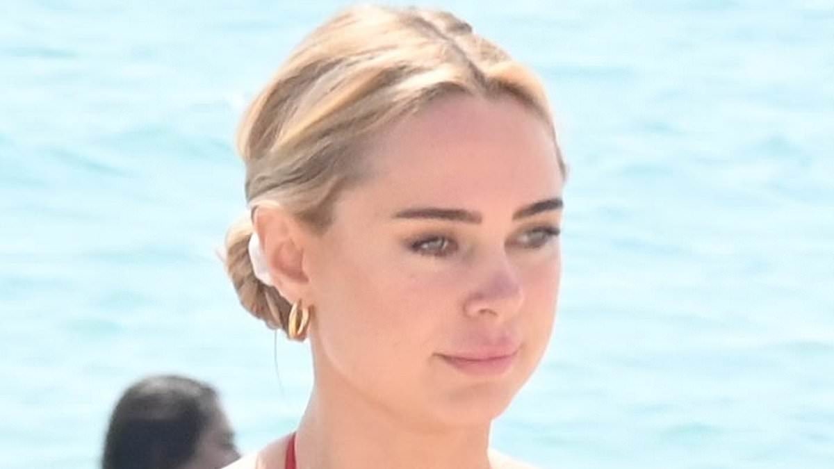 Kimberley Garner shows off her jaw-dropping figure in a skimpy red bikini as she hits the beach in Cannes