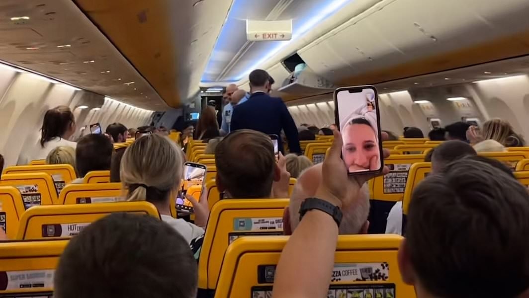 EXCLUSIVE Moment 'drunk' British woman is dragged off Ryanair flight and thrown to the floor by security after 'she assaulted passengers and forced plane to divert to Portugal'