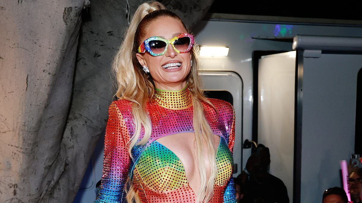 Paris Hilton, 44, almost spills out of cut-out pride minidress as she glows during performance