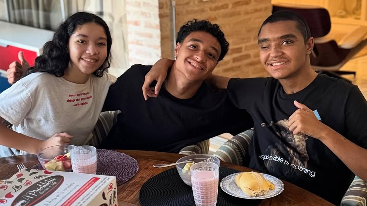 Former Brazil star's son, 19, who was left 'brain dead' after lorry crash on his way to first training session returns home to his family three months on from horror accident