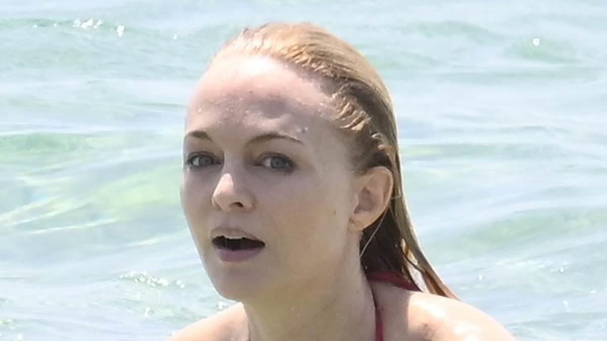 EXCLUSIVE Heather Graham, 55, stuns with busty age-defying display in VERY revealing bikini during wild beach outing