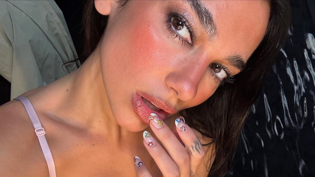 Dua Lipa dances the night away in pink satin mini dress as she shares more snaps from wild Wembley celebrations before tour heads to Anfield