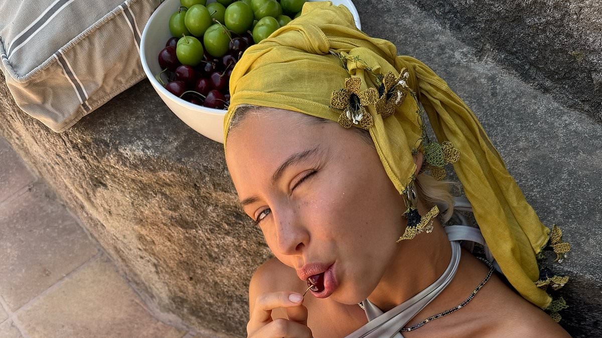 Iris Law shows off her toned midriff in a halterneck bikini as she gives an insight into her summer
