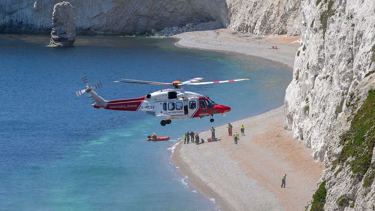 Woman found dead at Durdle Door on hottest day of the year was discovered below 300ft cliff and died of multiple injuries, inquest hears