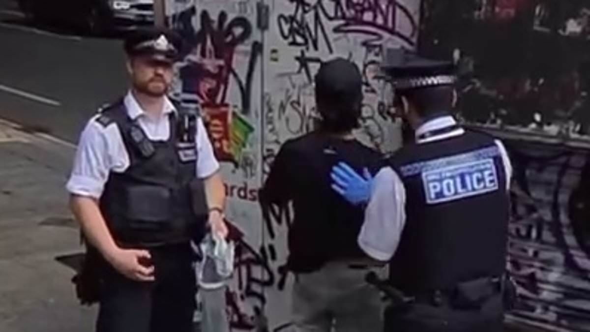 Moment 'Deliveroo rider' is held in police crackdown on migrants working illegally after fast food delivery bikes were found outside Home Office-funded hotel