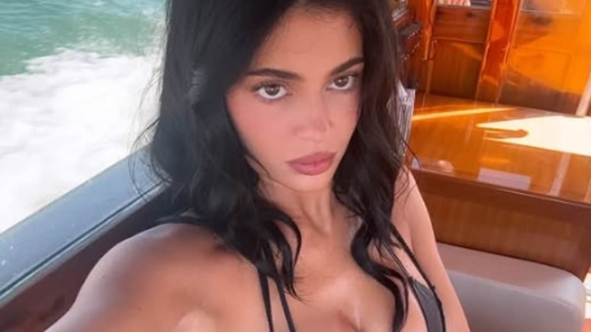 Kylie Jenner sizzles in a busty black string bikini top as she joins ab-baring sister Kendall for pool party in Venice as Jeff Bezos and Lauren Sanchez's $20M wedding festivities continue