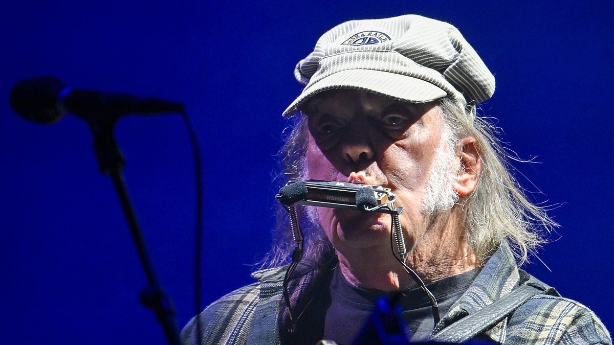Neil Young performs his headline set at Glastonbury to a 'sparse' crowd after making major U-turn and allowing performance to be broadcast on BBC