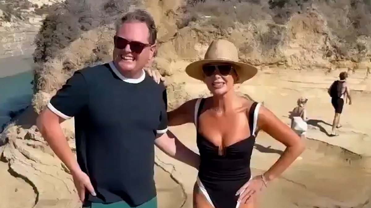 Amanda Holden, 54, sizzles in a plunging swimsuit as she shows off her age-defying figure whilst joking around with Alan Carr in Greece