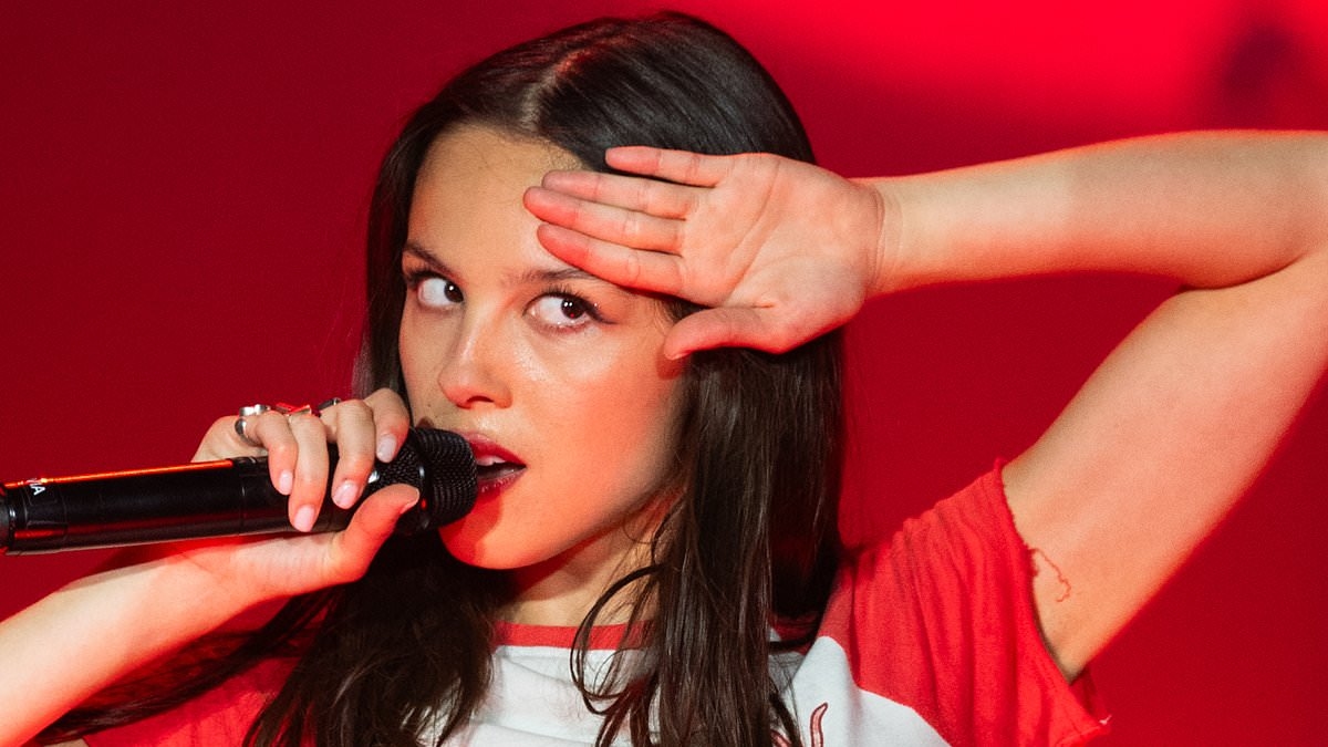 Olivia Rodrigo wows in Union Jack hot pants as she shares her 'love' for England before bringing out The Cure's Robert Smith as a surprise guest in 'amazing' Glastonbury set