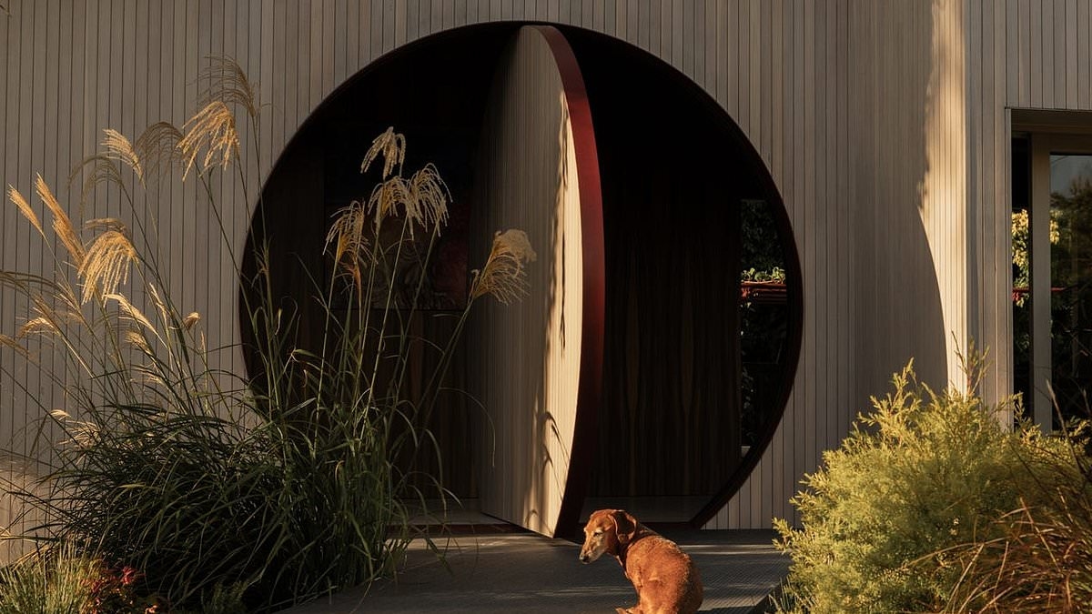 An enticing round door in a coastal Aussie suburb marks the entrance to a spectacular home quite unlike anything nearby: 'It's paradise'
