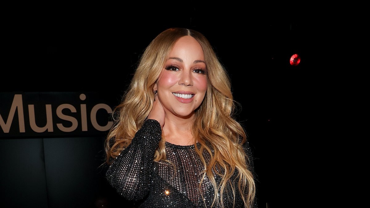 Mariah Carey flaunts her enviable curves in a glittering mesh gown as she teases her upcoming album at Apple Music 10th anniversary bash