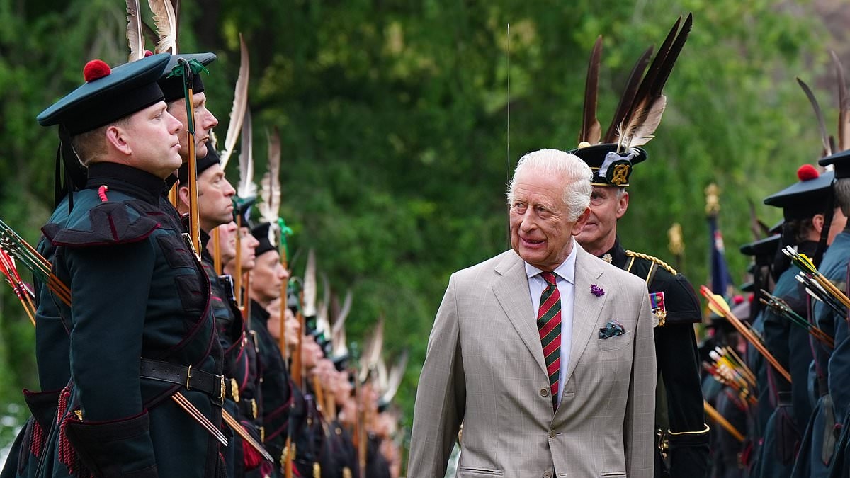 King Charles appears in high spirits during military parade at Palace of Holyroodhouse - after he was given the keys to Edinburgh in annual Royal Week tradition