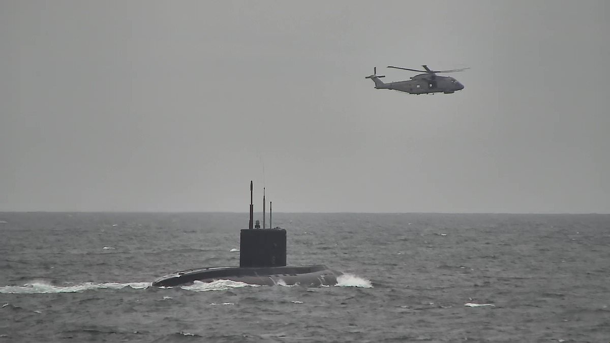 Moment Royal Navy warship and helicopters shadow a Russian submarine as it glides past the English coast