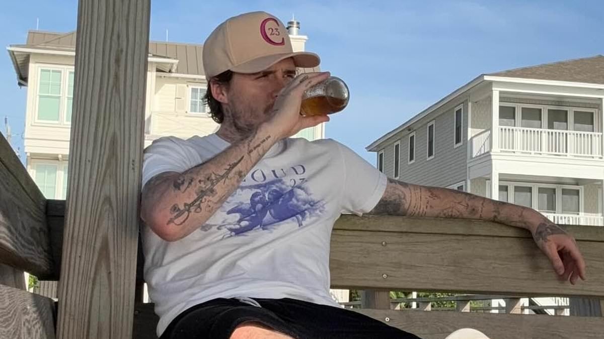 Brooklyn Beckham stares blankly in lonesome snaps as he sips on whiskey alone amid heartbreaking family feud