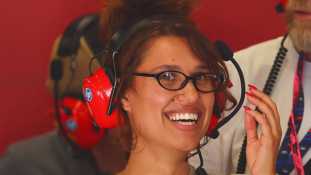 Raye can't contain her smile as she spends the day in the Ferrari garage at Silverstone Circuit amid Lewis Hamilton romance rumours