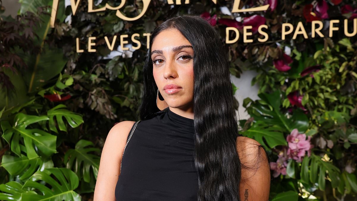 Madonna's daughter Lourdes Leon wears a fitted dress with a thigh-high leg slit as she joins Iris Law at YSL dinner during Paris Fashion Week
