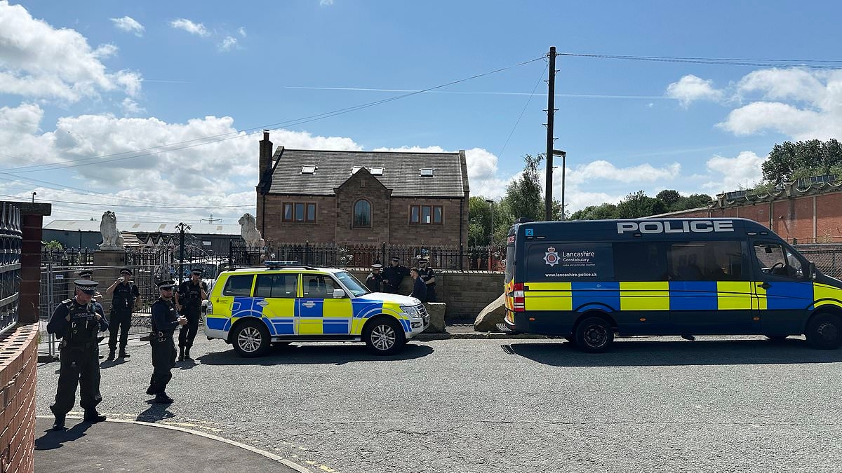 'Army' of police shut down crime boss 'Hotdog' Smith's house on illegal scrapyard as wife says she will be forced to live 'in a TENT'