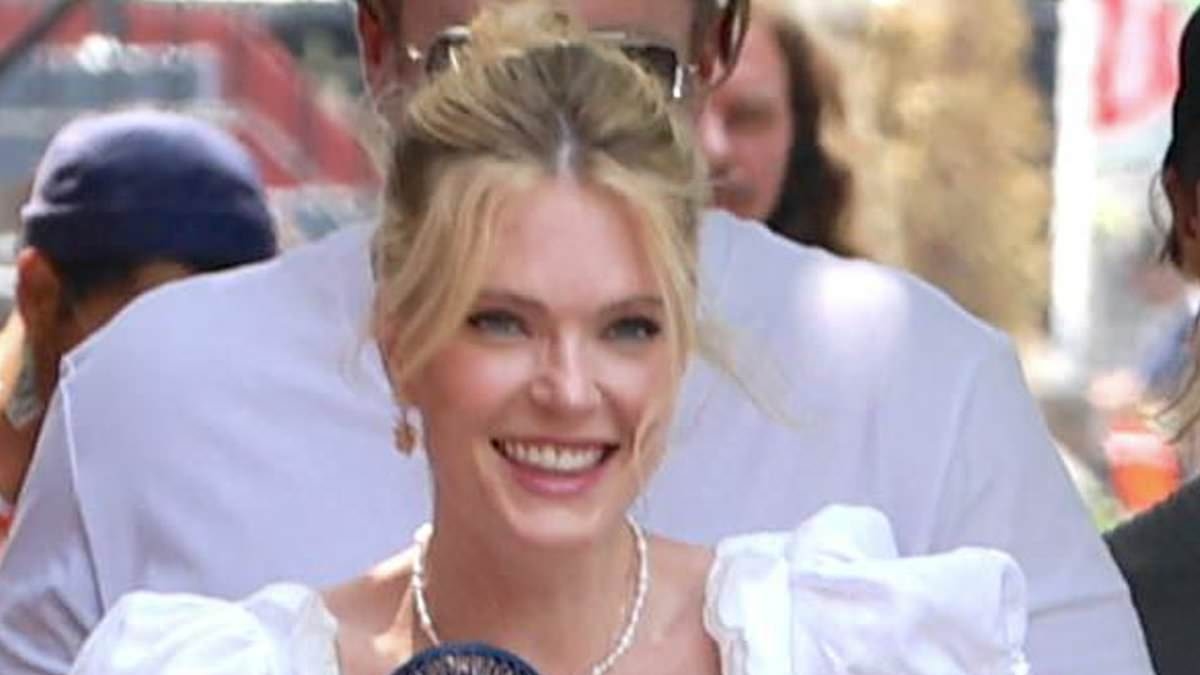 Penn Badgley and Meghann Fahy fan themselves in the summer heat as they film new romcom You Deserve Each Other in NYC