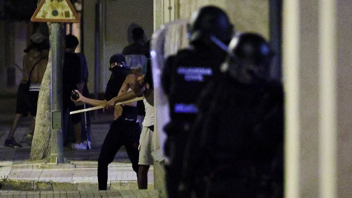 Spanish town that has become the centre of anti-migrant violence sees another night of unrest as police - and hard-right agitators - descend after man, 68, was attacked by 'three Moroccans'