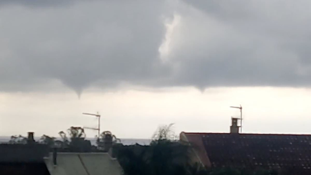 Ferocious storms lash Spain with 'two swept away' by flash floods, waterspouts lashing the coast and a woman struck by lightning… as wildfires close in on tourist hotspot