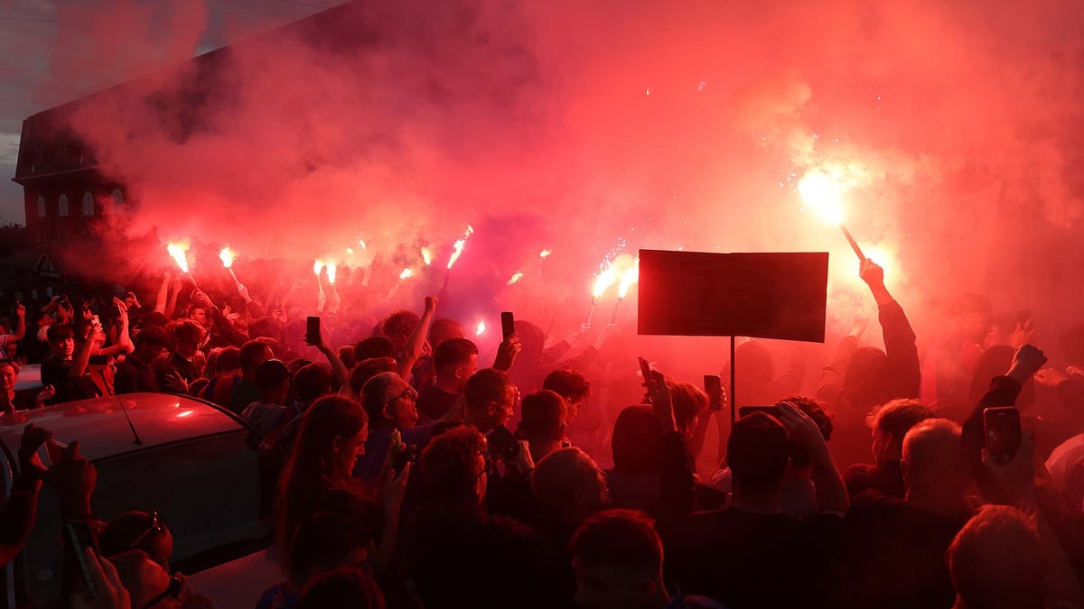 Crystal Palace fans launch fierce protest against UEFA's decision to kick them from the Europa League - as they march with flares and GRAFFITI Selhurst Park