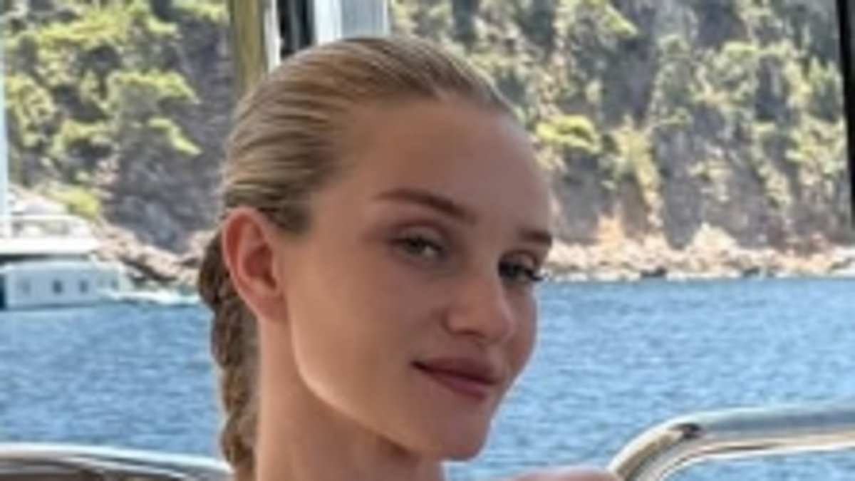 Rosie Huntington-Whiteley shows off her incredible figure in a white bikini during family boat trip