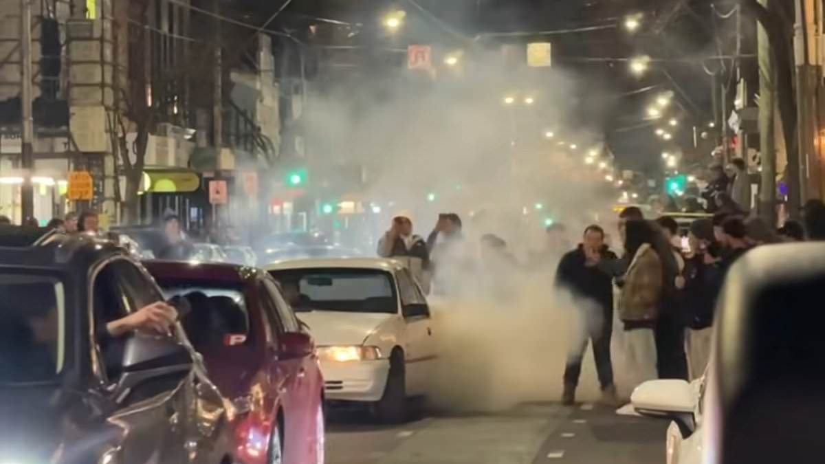Wild moment gang of car hoons shuts down one of Australia's busiest nightclub precincts - as crowds out for dinner are choked in tyre smoke
