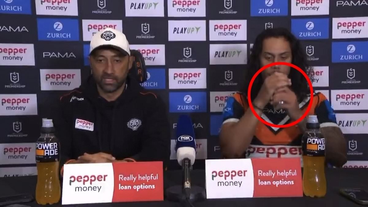 Footy star Jarome Luai is busted trying to cover up his VERY unhealthy post-match drink in bizarre act at press conference