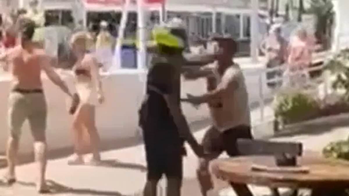 Shocking moment Spanish cop slaps tourist 'who swore at him after complaining about police treatment of African beach sellers' in Marbella