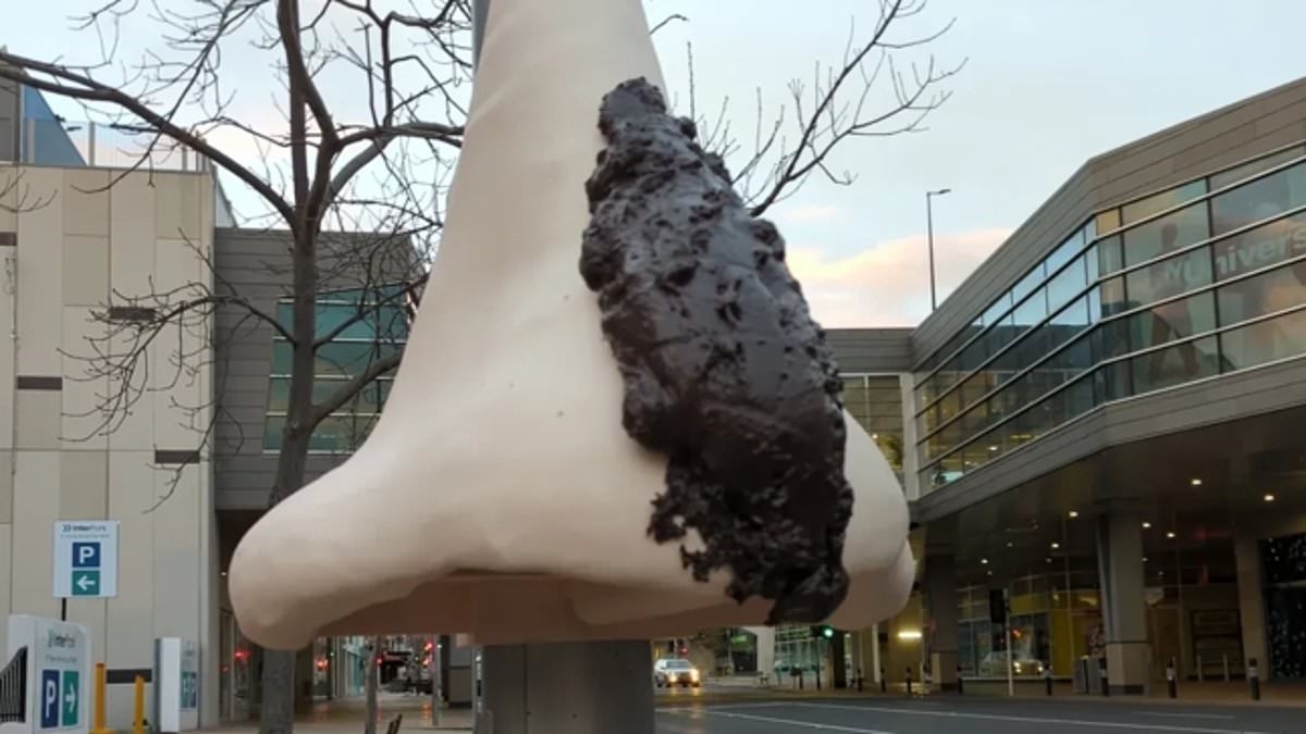 Australia's 'biggest brown-noser' politician named on protest sculpture - as Albanese government signs AUKUS deal with the UK