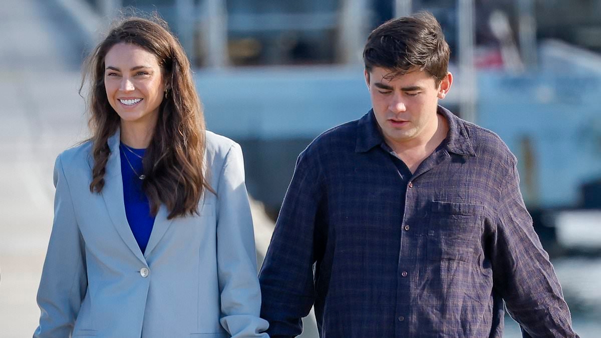 Something to tell us? MasterChef star Sarah Todd's bizarre accessory as she leaves a wedding venue with younger boyfriend Declan Cleary in Melbourne