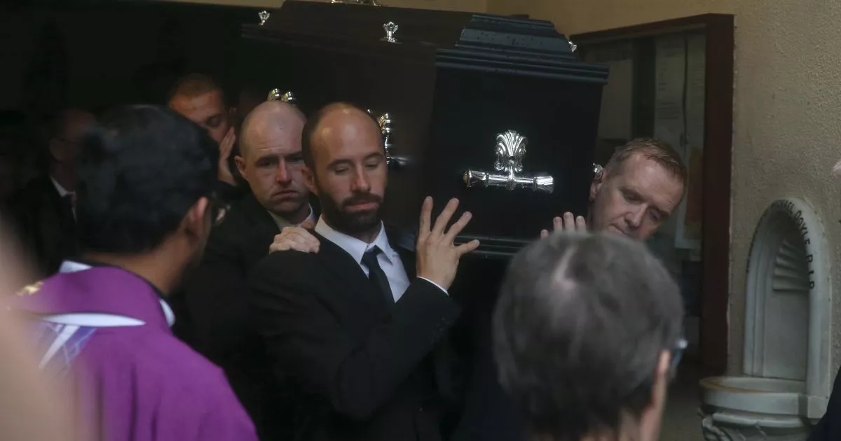 Funeral mass hears photographer was 'solid bloke' who loved his family dearly