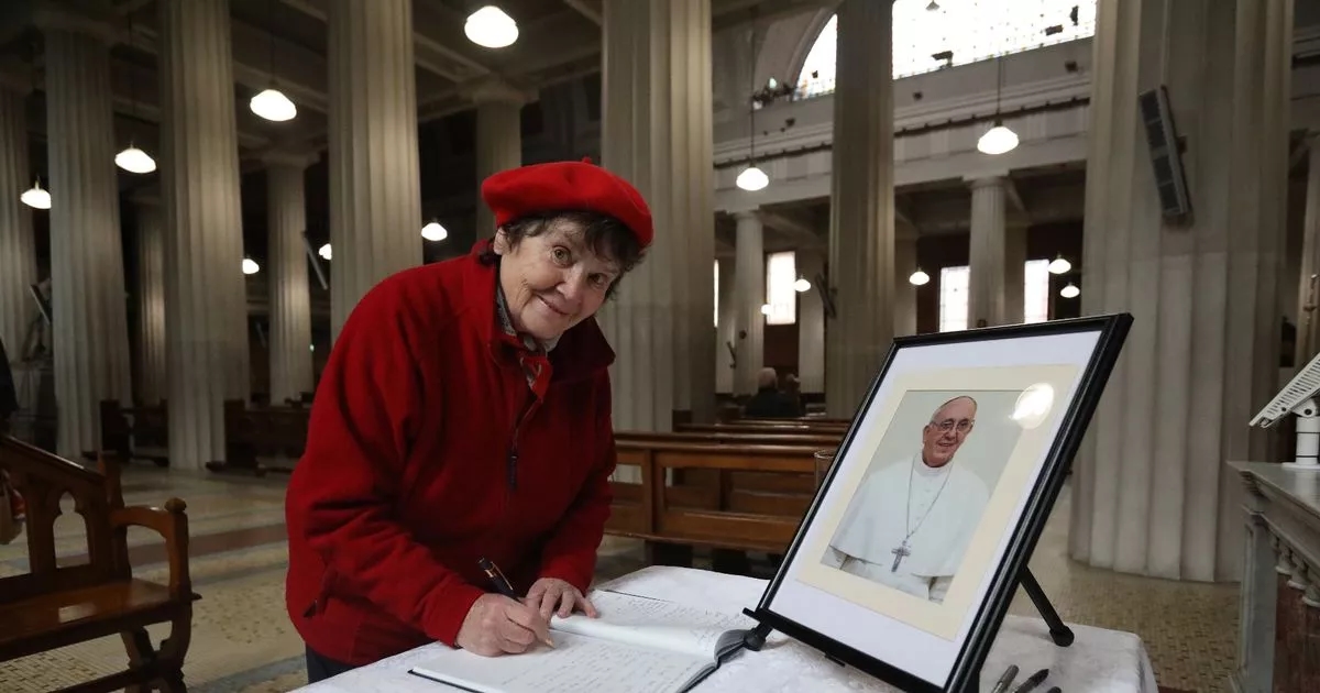 Crowds gather to sign book of condolences for Pope Francis at Pro Cathedral