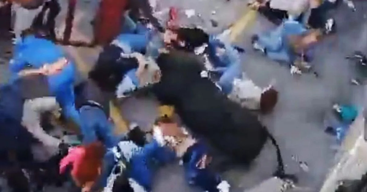 Horrifying moment bull rampages into crowd of children at Easter festival after smashing barrier
