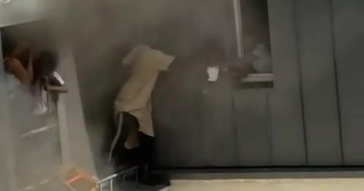 ​Incredible moment hero caretaker saves four babies from apartment fire