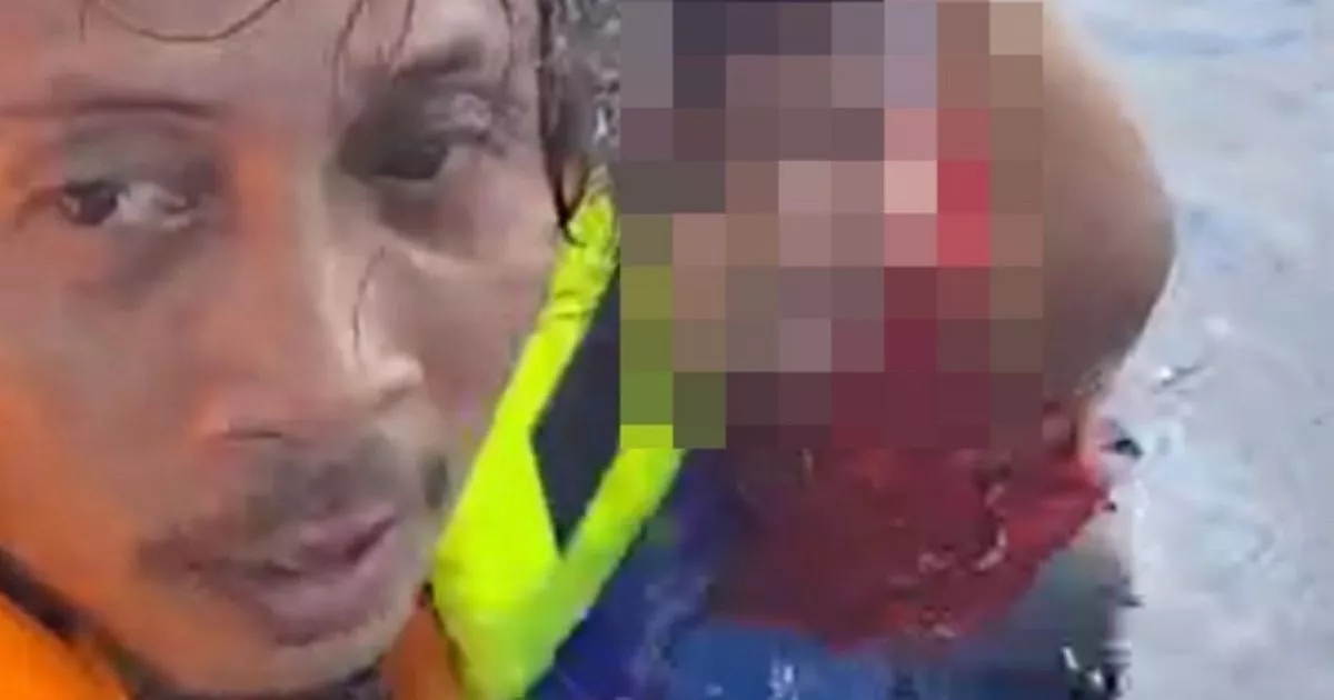 Indonesian ferry fire survivor clings to tiny baby after abandoning ship in water