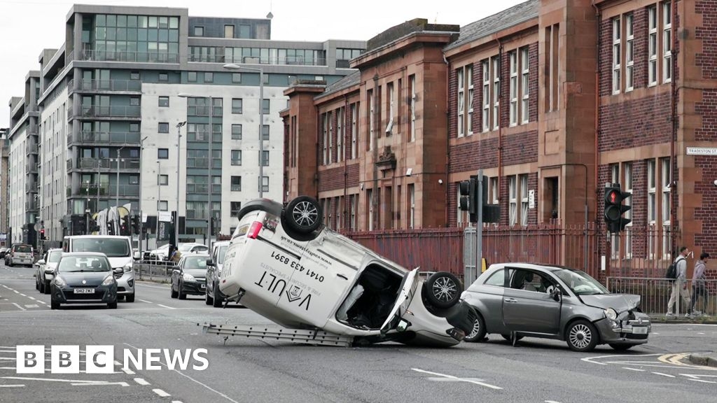 Woman charged after van flips on roof in Glasgow crash