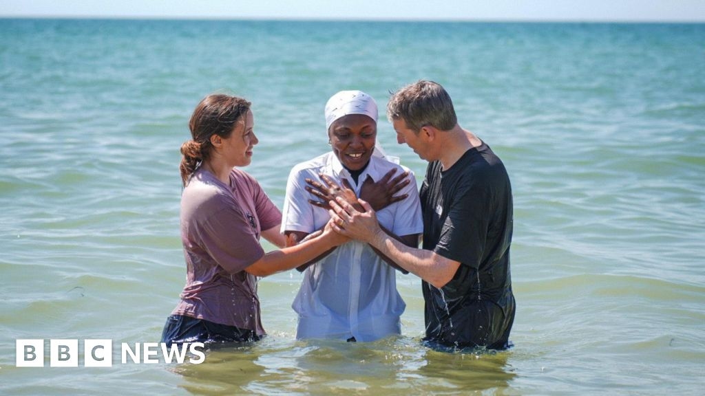 Hundreds gather at Bournemouth beach for mass baptism in the sea