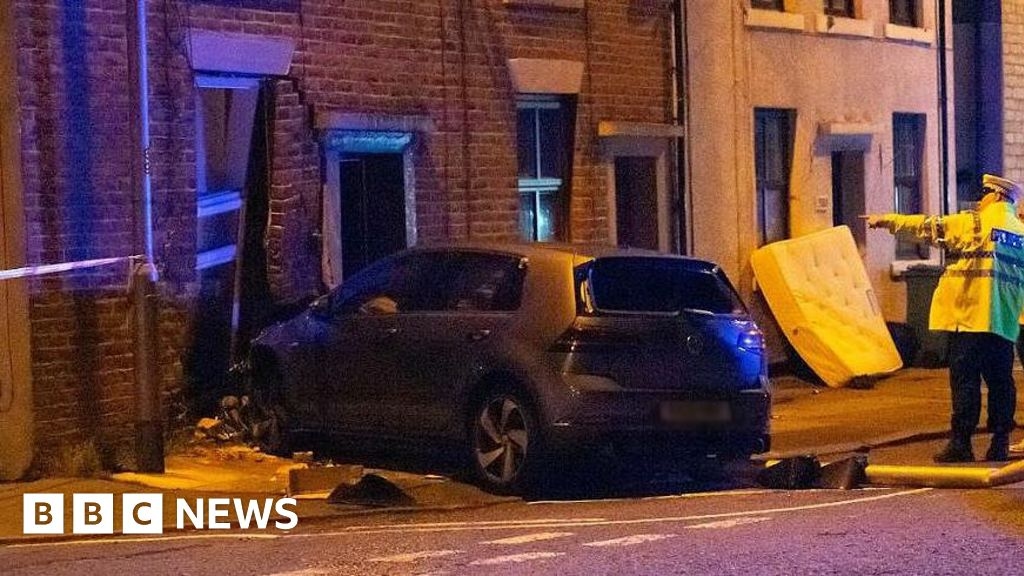 Car smashes into front of house in Rochdale in early hours