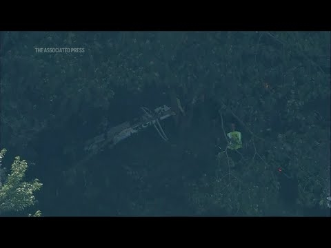 Skydiving plane goes off New Jersey runway and crashes into woods, sending 15 to hospital
