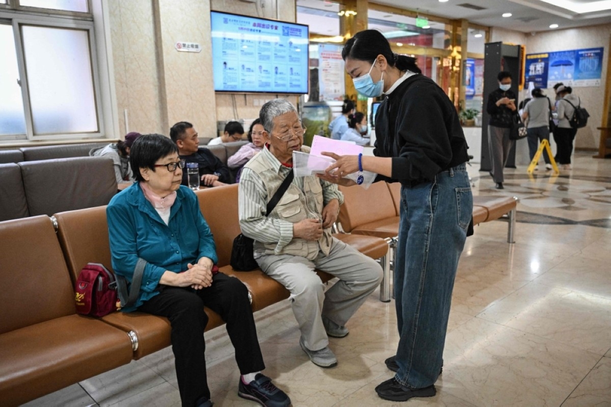 ‘Companions' ease pain of China's bustling and bamboozling hospitals