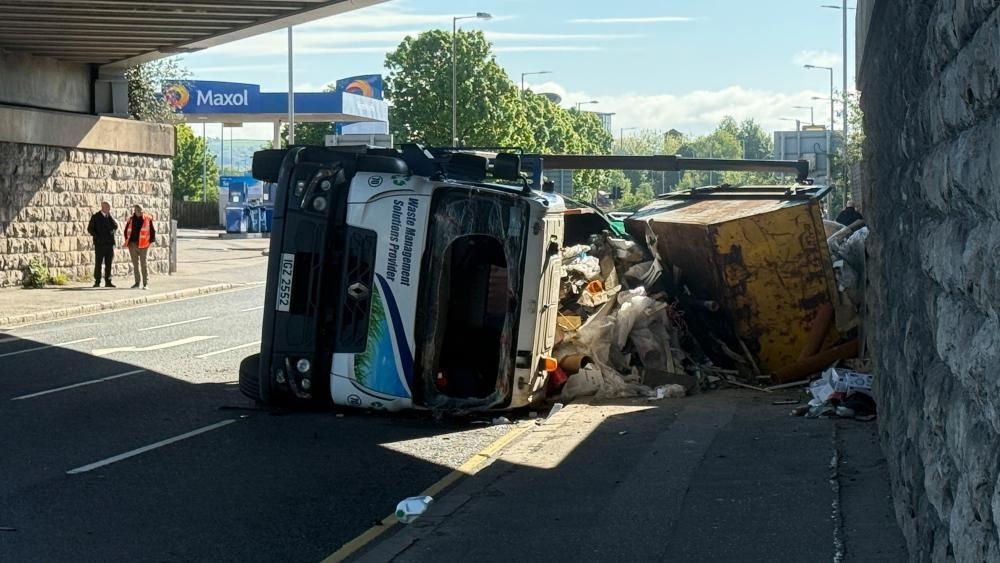 Overturned skip lorry causing delays in Belfast