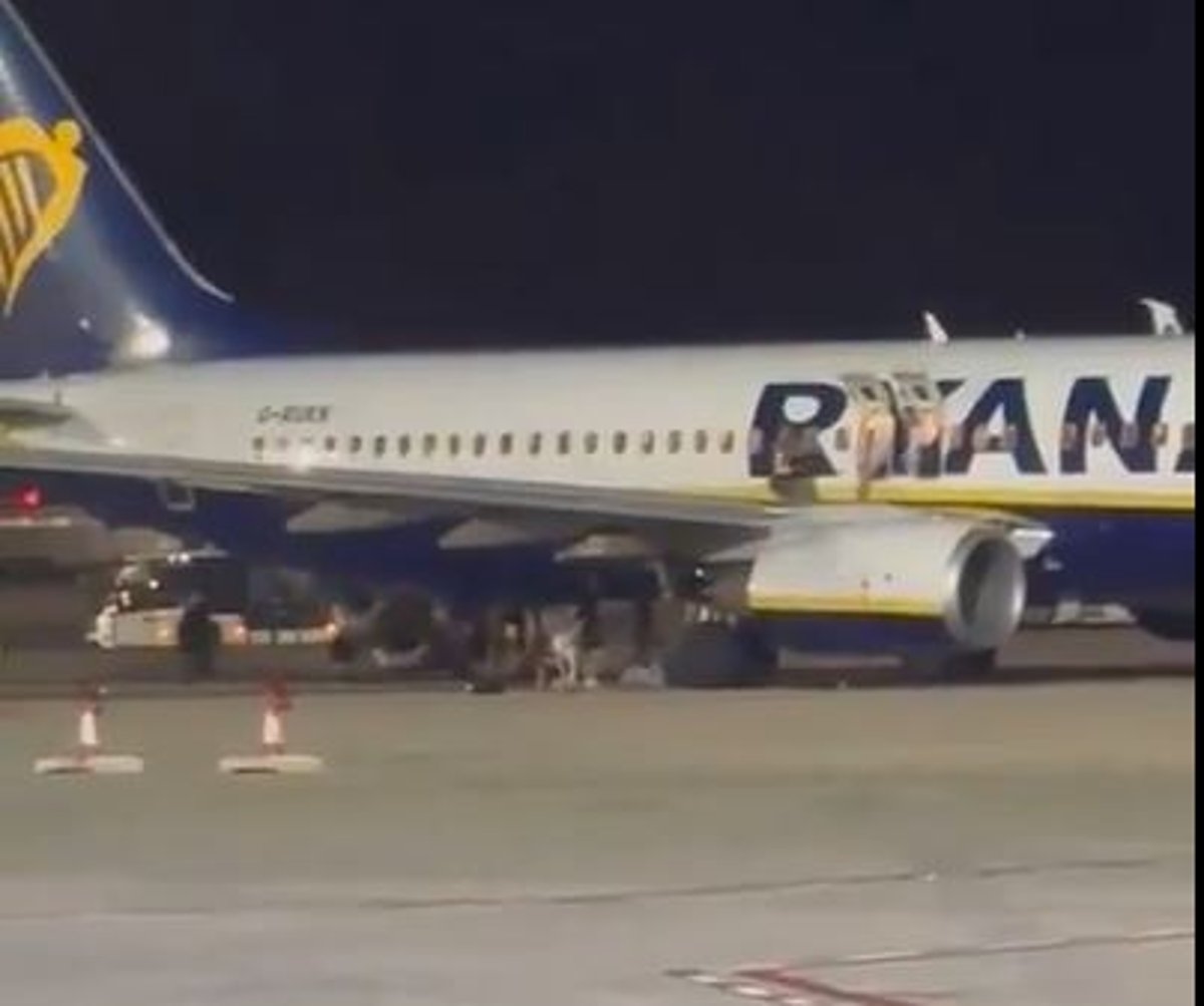 At least 18 injured as UK-bound Ryanair passengers leap onto wing after fire alert in Majorca
